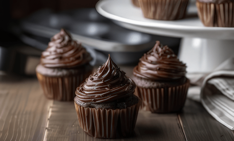 A plate of beautifully decorated chocolate cupcakes with chocolate frosting and sprinkles. A plate of beautifully decorated chocolate cupcakes with chocolate frosting and sprinkles.