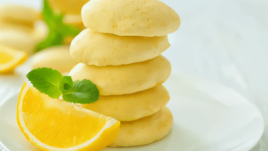 Vegan lemon sandwich cookies arranged on a plate with fresh mint leaves. Vegan lemon sandwich cookies arranged on a plate with fresh mint leaves.
