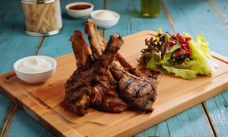 A plate of Sazon Spicy Chops garnished with fresh herbs and served with grilled vegetables. A plate of Sazon Spicy Chops garnished with fresh herbs and served with grilled vegetables.