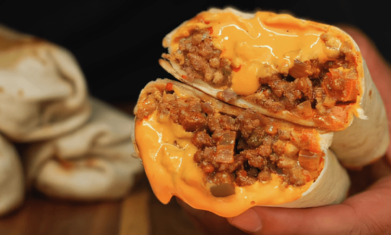 A delicious Nacho Cheese Beef Burrito cut open to reveal the savory beef and melted cheese filling. A delicious Nacho Cheese Beef Burrito cut open to reveal the savory beef and melted cheese filling.