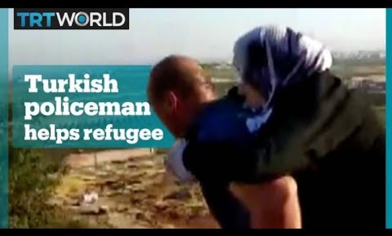Turkish policeman helps injured Syrian woman Turkish policeman helps injured Syrian woman