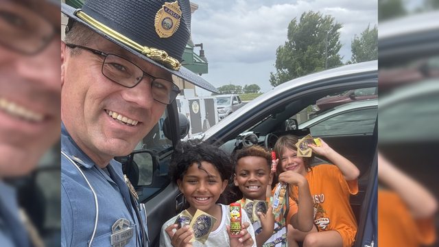 Trooper Ben shares smiles and goodies with delighted kids outside his patrol car, turning a routine stop into a heartwarming moment of connection! Trooper Ben shares smiles and goodies with delighted kids outside his patrol car, turning a routine stop into a heartwarming moment of connection!