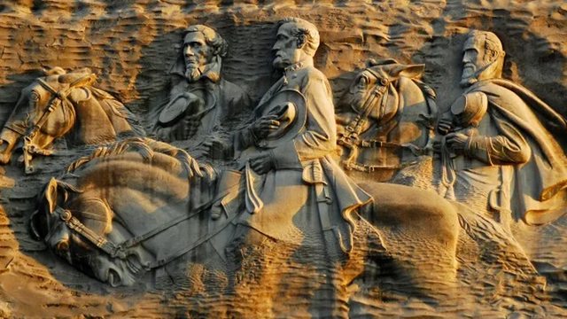 A majestic carving of Jefferson Davis, Robert E. Lee, and Stonewall Jackson etched into Georgia’s rock, symbolizing a contested chapter of American history. A majestic carving of Jefferson Davis, Robert E. Lee, and Stonewall Jackson etched into Georgia’s rock, symbolizing a contested chapter of American history.