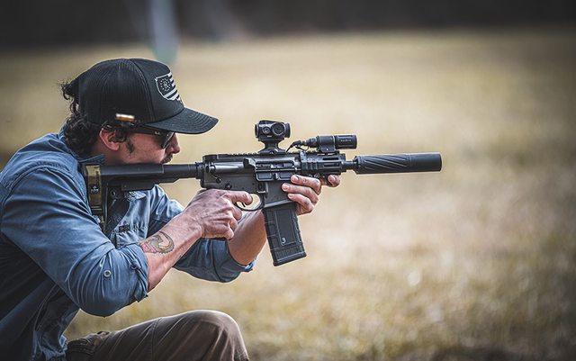 A short-barreled rifle (SBR) equipped with a silencer attachment, designed to reduce noise for hearing protection, not to silence the firearm completely. (Silencer Central) A short-barreled rifle (SBR) equipped with a silencer attachment, designed to reduce noise for hearing protection, not to silence the firearm completely. (Silencer Central)