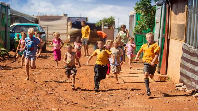 Children play in a White South African squatter camp, a stark symbol of the ANC’s alleged strategy to erode Afrikaner communities through engineered poverty. Children play in a White South African squatter camp, a stark symbol of the ANC’s alleged strategy to erode Afrikaner communities through engineered poverty.