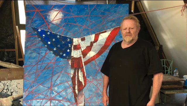 John Rogers standing next to his painting Dues Ex Machina. John Rogers standing next to his painting Dues Ex Machina.
