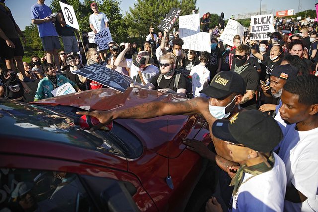 Vehicle surrounded by protestors. Vehicle surrounded by protestors.