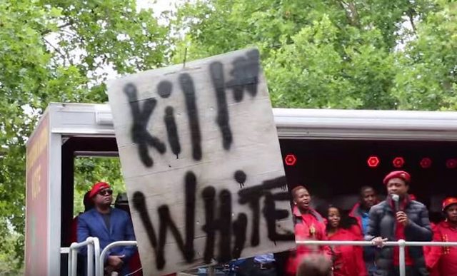 EFF members holding up "Kill White" sign. EFF members holding up "Kill White" sign.
