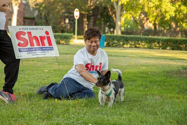 Congressman Shri Thanedar petting a dog. Congressman Shri Thanedar petting a dog.