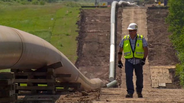 A worker inspects a pipeline, ensuring safety as PHMSA's new data-driven enforcement priorities target high-risk areas to protect communities. A worker inspects a pipeline, ensuring safety as PHMSA's new data-driven enforcement priorities target high-risk areas to protect communities.