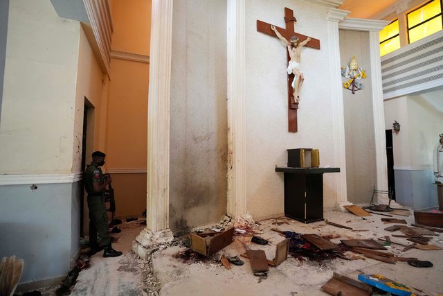 A police officer stands guard on June 6, 2022 inside St. Francis Xavier Catholic Church in Owo, Nigeria, a day after an attack against Christian worshipers there. A police officer stands guard on June 6, 2022 inside St. Francis Xavier Catholic Church in Owo, Nigeria, a day after an attack against Christian worshipers there.