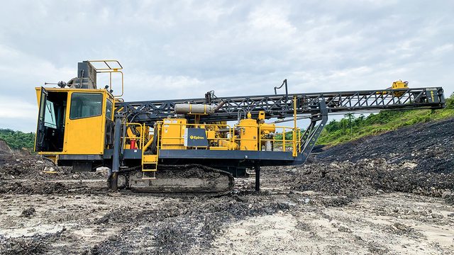 A powerful blasthole drill, used in mining to create precise holes for explosives, breaking rock to unearth valuable minerals. A powerful blasthole drill, used in mining to create precise holes for explosives, breaking rock to unearth valuable minerals.