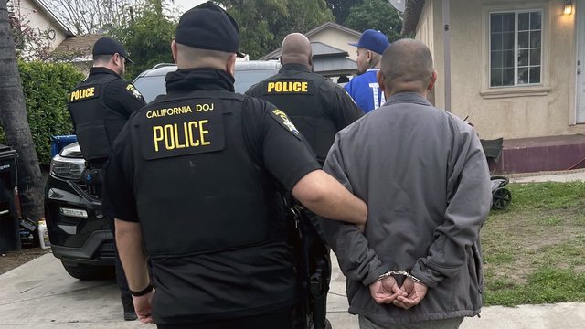 California DOJ Police Officers and two of the suspects. California DOJ Police Officers and two of the suspects.