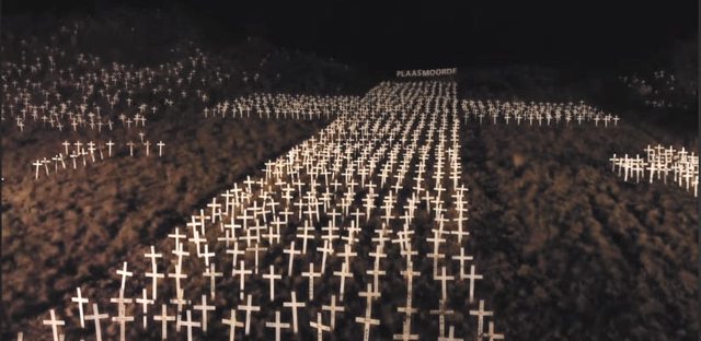Hundreds of white crosses, each representing a farm murder, form a large cross in silent tribute. Hundreds of white crosses, each representing a farm murder, form a large cross in silent tribute.