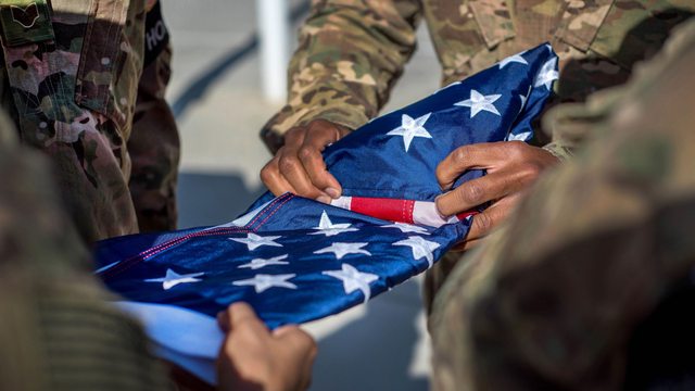 U.S. soldiers carefully fold the American flag, each of the 13 folds carrying a profound symbol of life, sacrifice, and national pride. U.S. soldiers carefully fold the American flag, each of the 13 folds carrying a profound symbol of life, sacrifice, and national pride.