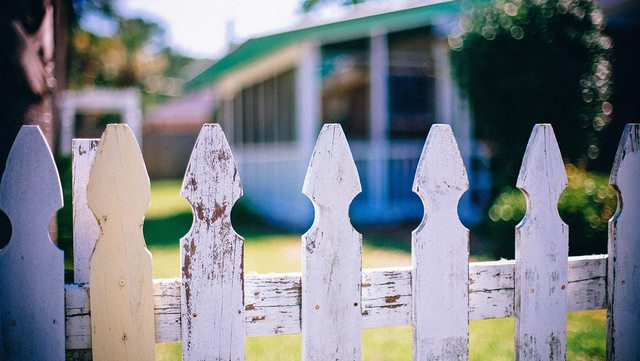 Classic charm meets security: This white picket fence home stands as a symbol of American pride, raising questions about who should own our nation's heartland. Classic charm meets security: This white picket fence home stands as a symbol of American pride, raising questions about who should own our nation's heartland.