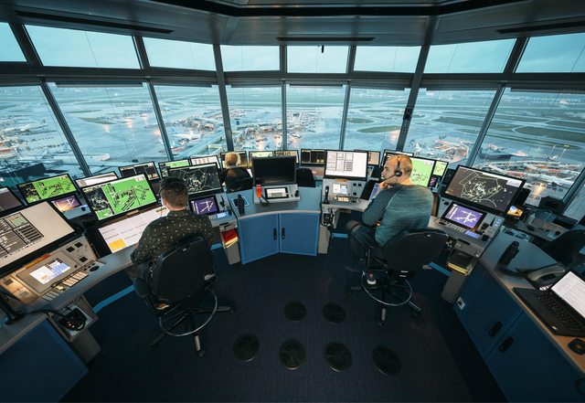 Air Traffic Controllers expertly manage the skies from the control tower, ensuring safe and efficient air travel. (LVNL) Air Traffic Controllers expertly manage the skies from the control tower, ensuring safe and efficient air travel. (LVNL)