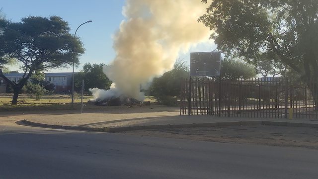 Grass cuttings bagged and illegally burned in South Africa, a common sight symbolizing unchecked emissions and climate funds lost to corruption, mocking ambitious climate goals. Grass cuttings bagged and illegally burned in South Africa, a common sight symbolizing unchecked emissions and climate funds lost to corruption, mocking ambitious climate goals.