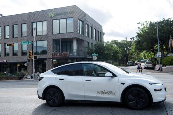 A Tesla Robotaxi inappropriately driving a parked car A Tesla Robotaxi inappropriately driving a parked car