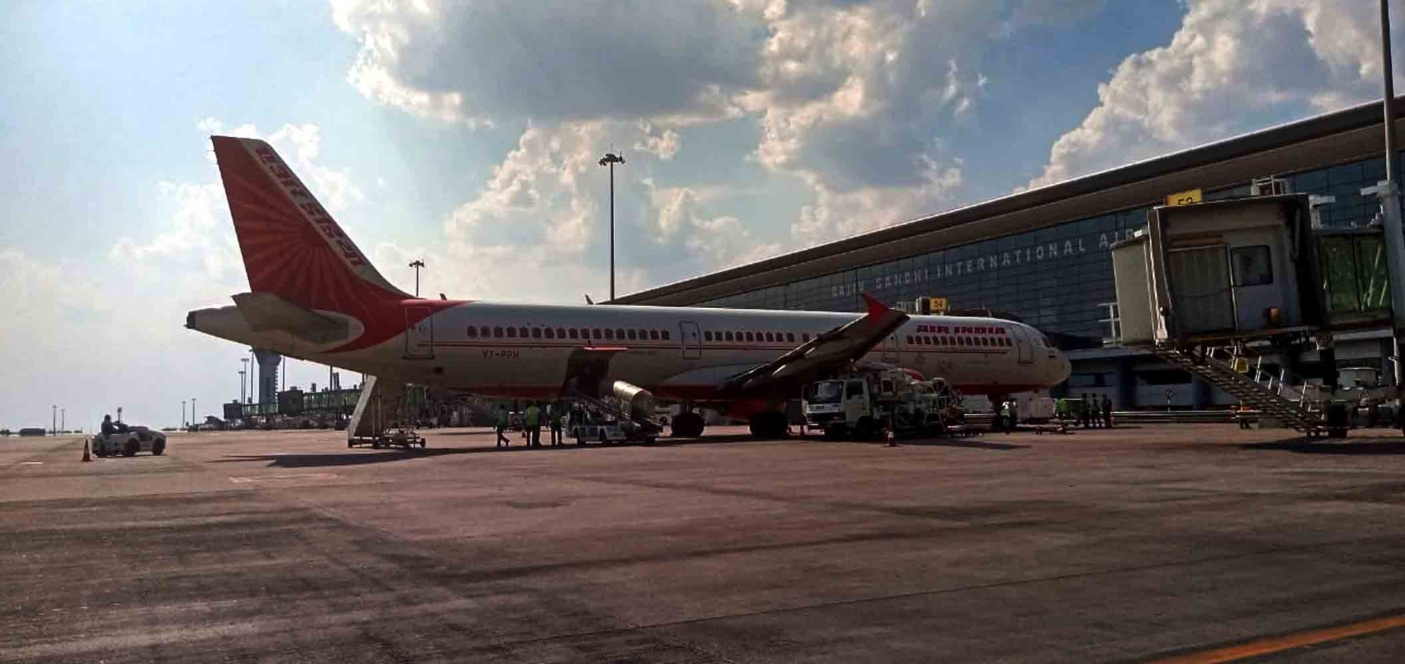 Airplane at airport gate with reduced landing parking charges Airplane at airport gate with reduced landing parking charges