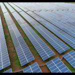 Solar workers installing panels on rooftop creating green jobs in India Solar workers installing panels on rooftop creating green jobs in India