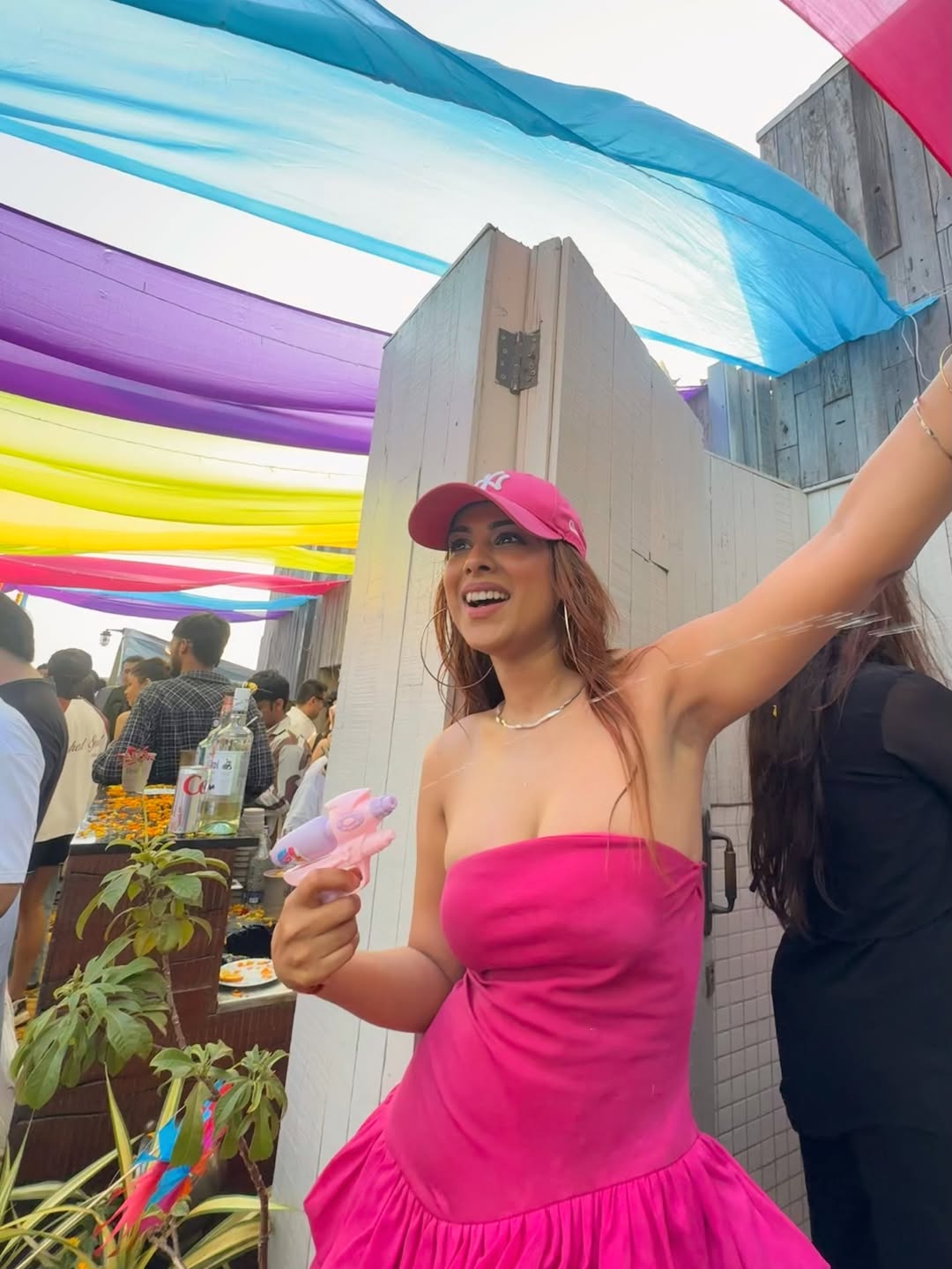 Nia Sharma holding tiny water gun in pink Holi outfit Nia Sharma holding tiny water gun in pink Holi outfit