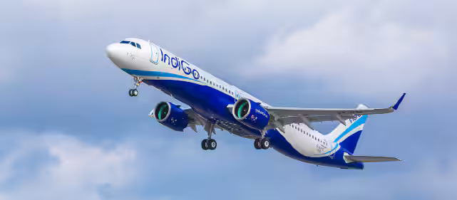 IndiGo airplane at airport with fuel surcharge announcement graphic IndiGo airplane at airport with fuel surcharge announcement graphic