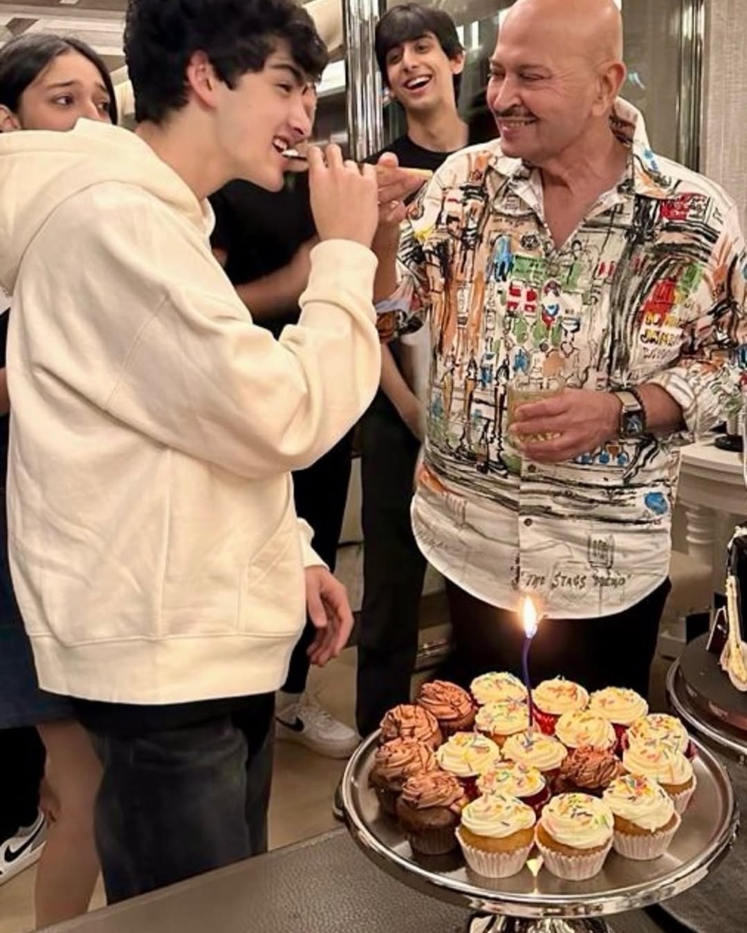 Rakesh Roshan feeding birthday cake to grandson Hrehaan Roshan Rakesh Roshan feeding birthday cake to grandson Hrehaan Roshan
