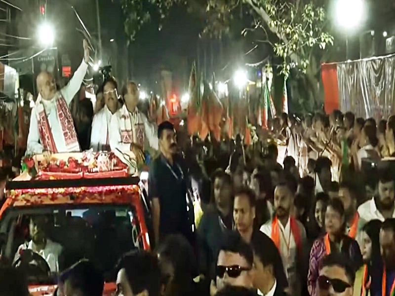 Home Minister Amit Shah greeting crowds during BJP roadshow in Guwahati Assam Home Minister Amit Shah greeting crowds during BJP roadshow in Guwahati Assam