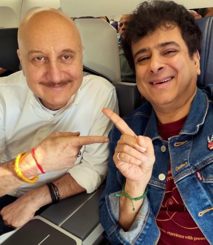 Palash Sen and Anupam Kher smiling together on an airplane Palash Sen and Anupam Kher smiling together on an airplane