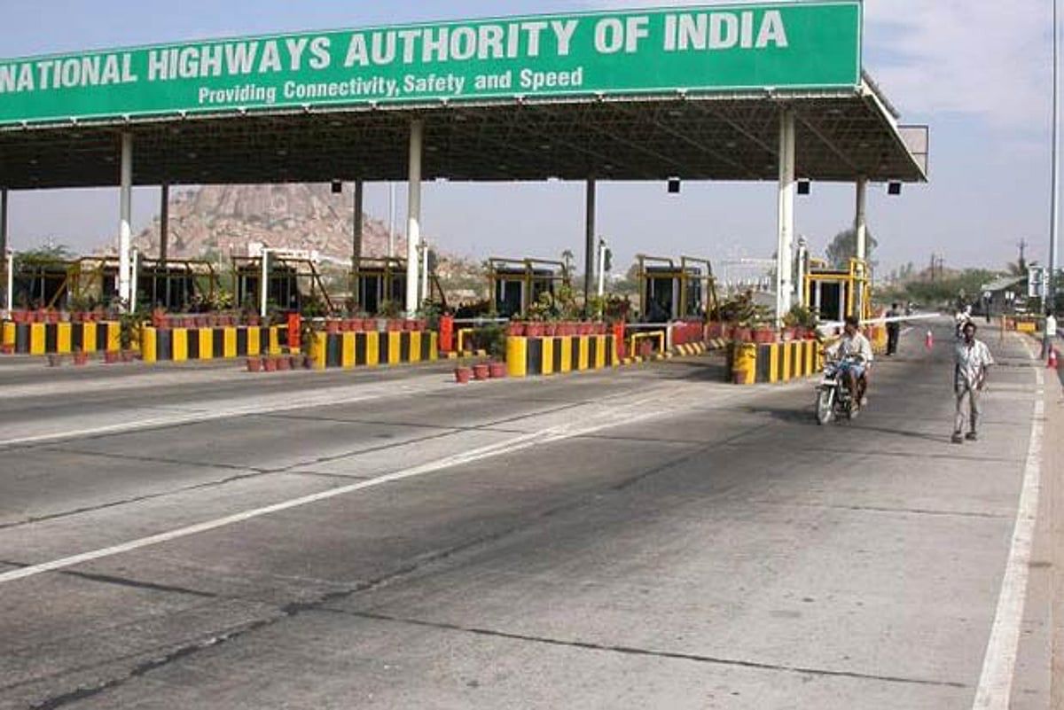 Digital toll payment system at highway plaza with FASTag scanner Digital toll payment system at highway plaza with FASTag scanner