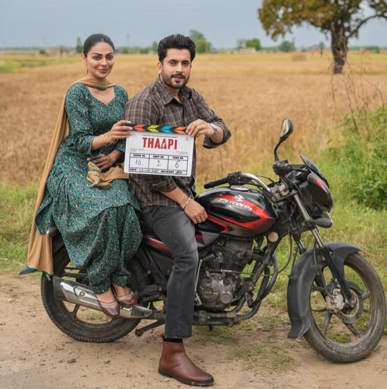 Sunny Singh and Neeru Bajwa on bike holding Thaapi film clapboard Sunny Singh and Neeru Bajwa on bike holding Thaapi film clapboard