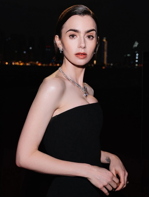 Lily Collins daughter Tove wearing bibs with hair in first ponytail Lily Collins daughter Tove wearing bibs with hair in first ponytail