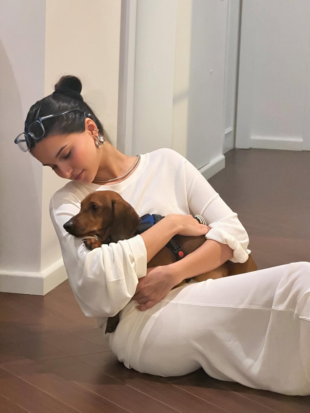 Tara Sutaria cuddling with her pet dog on the floor Tara Sutaria cuddling with her pet dog on the floor