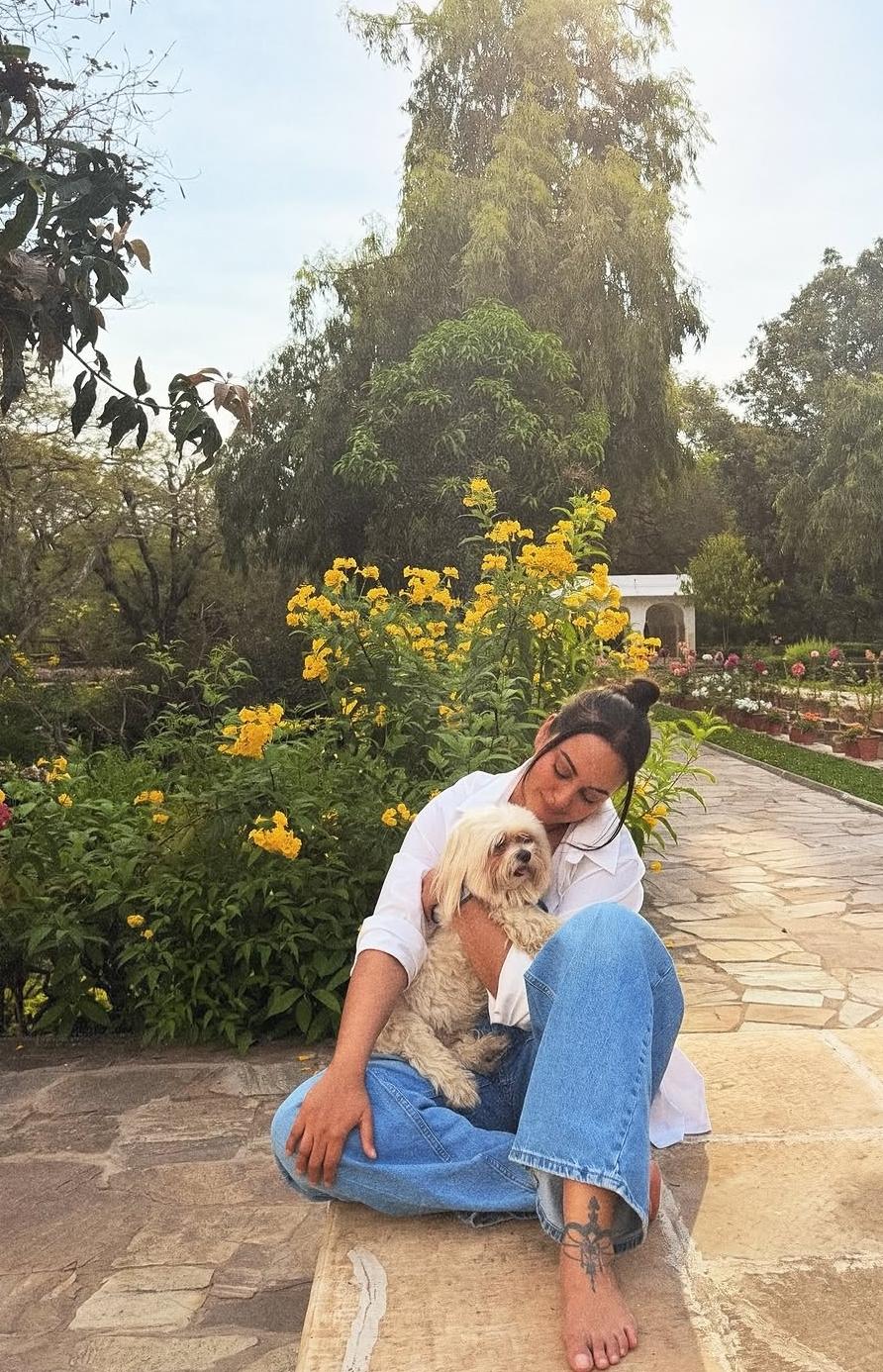 Sonakshi Sinha enjoying nature opathy in a garden with her pet dog Sonakshi Sinha enjoying nature opathy in a garden with her pet dog