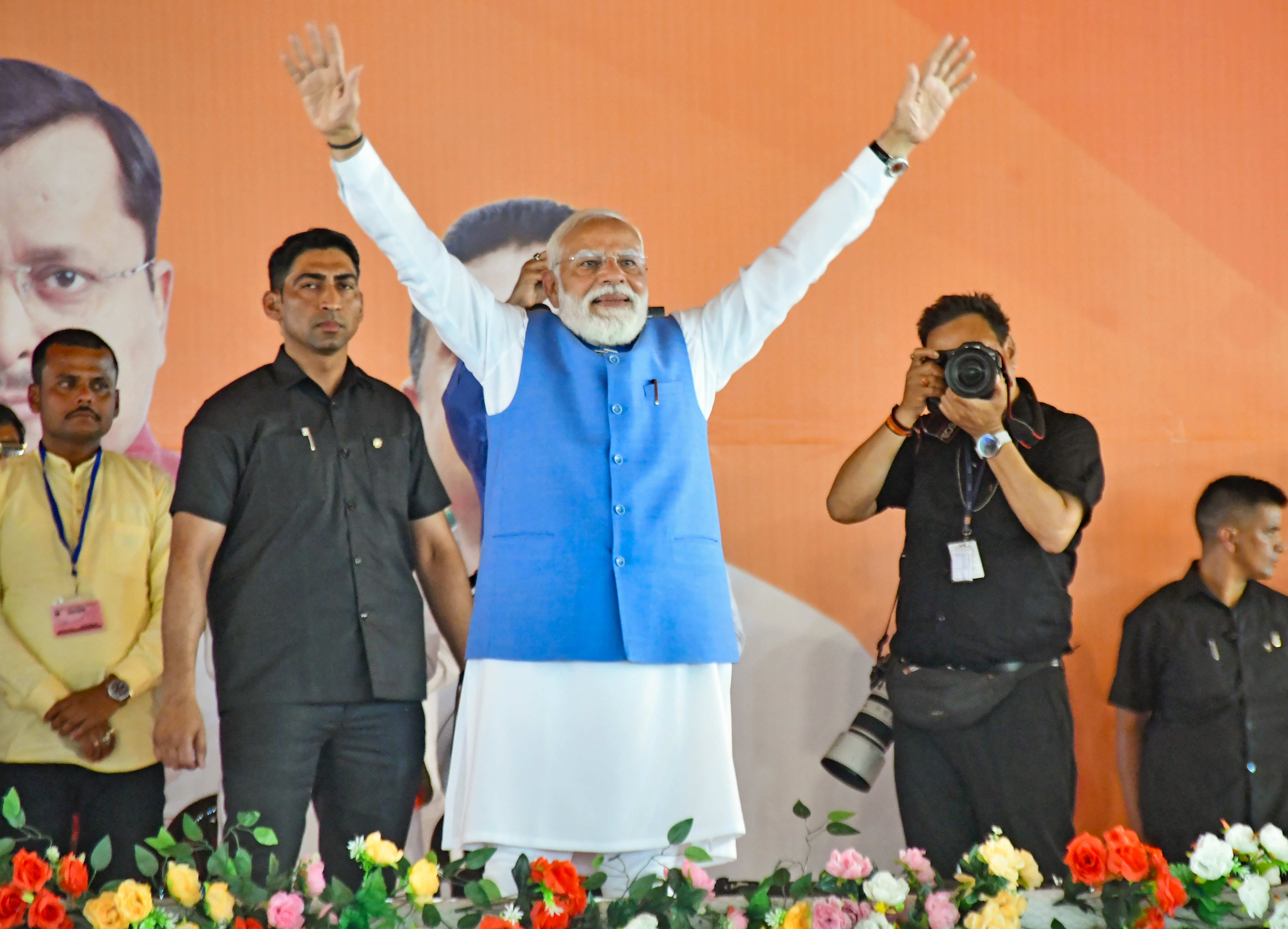 PM Narendra Modi during his road show in Siliguri waving to the crowd PM Narendra Modi during his road show in Siliguri waving to the crowd