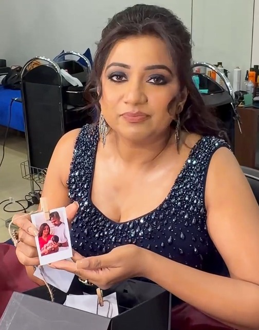 Shreya Ghoshal holding photos of her son Devyaan on Mother's Day Shreya Ghoshal holding photos of her son Devyaan on Mother's Day