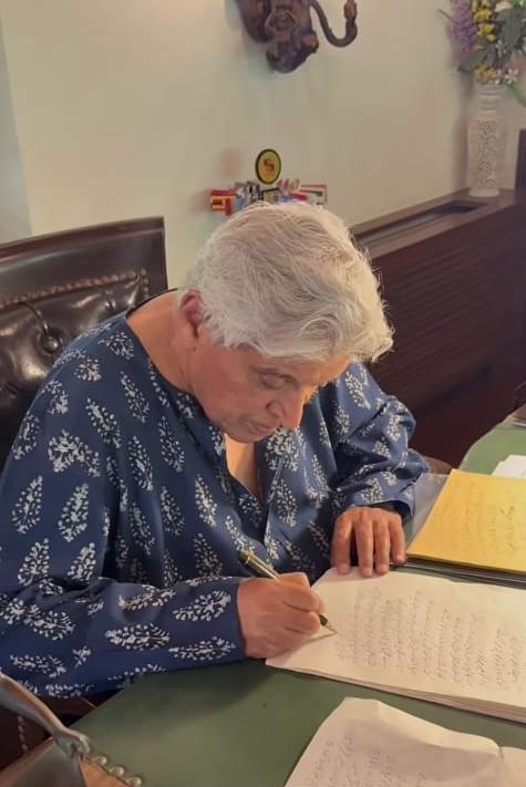 Javed Akhtar writing in Urdu with pen and paper in his study Javed Akhtar writing in Urdu with pen and paper in his study