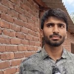 Rajouri poultry farm success story showing Ehtesham with chickens in his poultry unit Rajouri poultry farm success story showing Ehtesham with chickens in his poultry unit