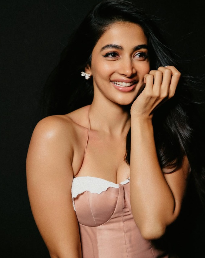Pooja Hegde walking backwards on a treadmill in orange crop top and shorts Pooja Hegde walking backwards on a treadmill in orange crop top and shorts