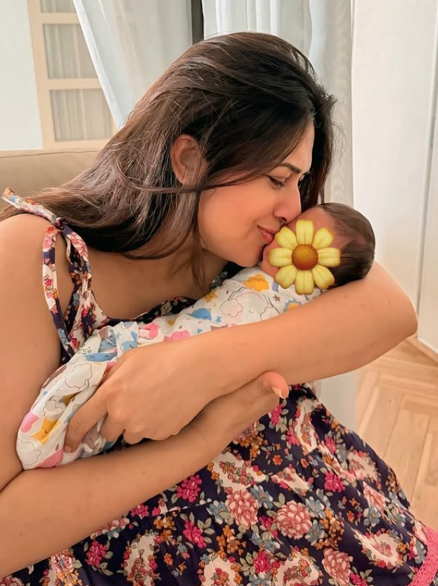 Divyanka Tripathi cradling twin babies with sunflower emoji covering faces Divyanka Tripathi cradling twin babies with sunflower emoji covering faces