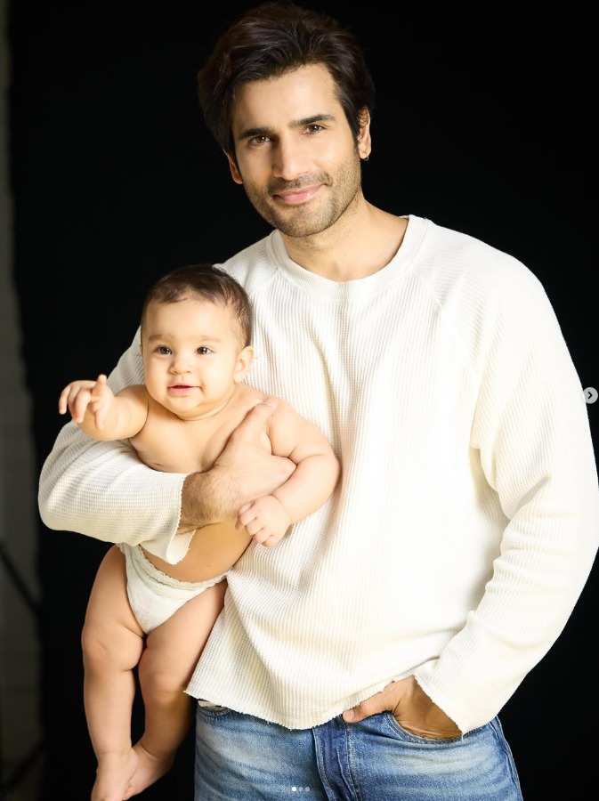 Karan Tacker cuddling his nephew Azarius in birthday post clarifying he is still single and seeking Karan Tacker cuddling his nephew Azarius in birthday post clarifying he is still single and seeking