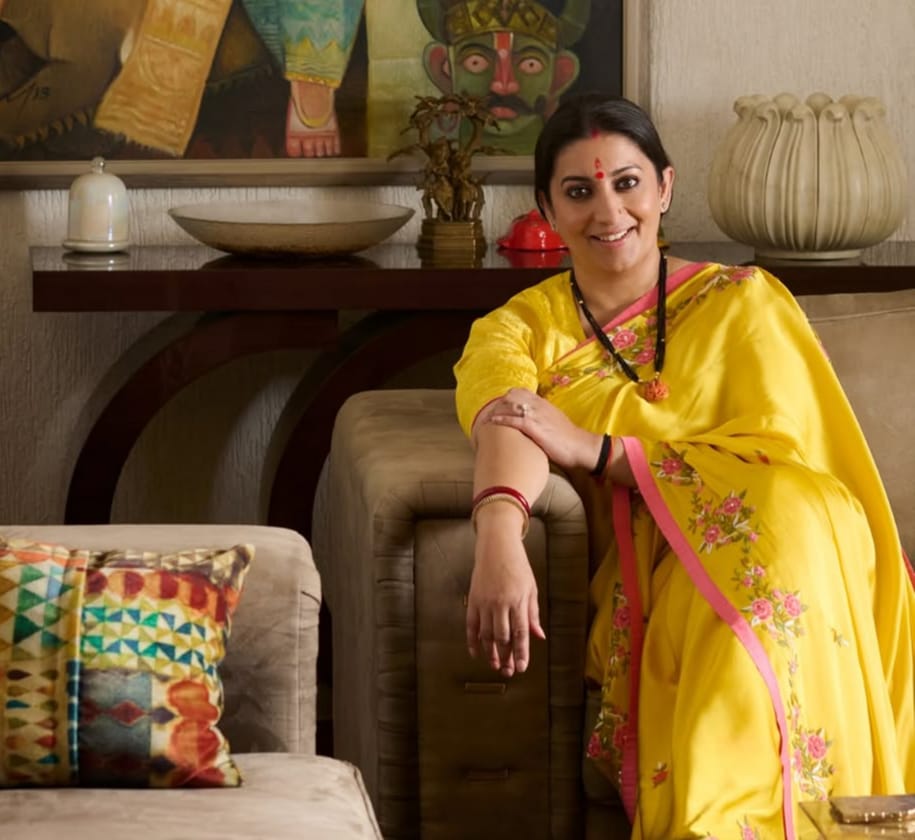 Smriti Irani sitting by a painting of a goddess, spreading message of self-worth and authenticity Smriti Irani sitting by a painting of a goddess, spreading message of self-worth and authenticity