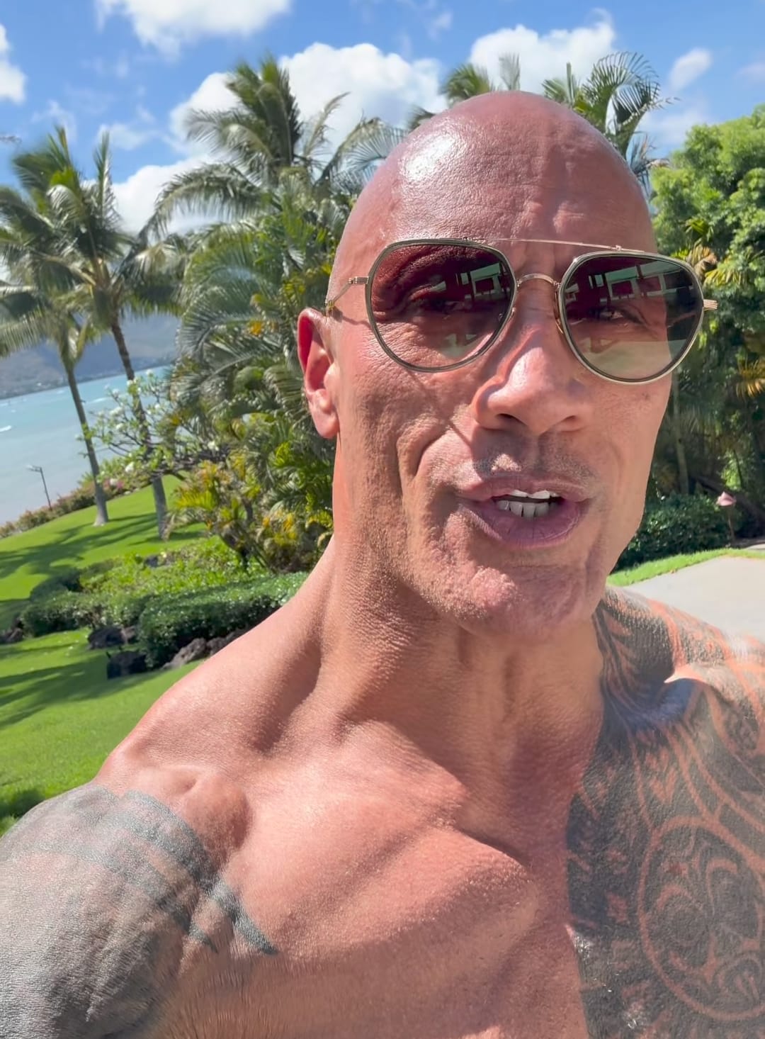 Dwayne Johnson wearing the Jumanji dice necklace prop on set Dwayne Johnson wearing the Jumanji dice necklace prop on set