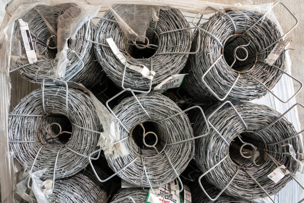 rolls of barbed wire await pickup by ranchers needing to repair their fences