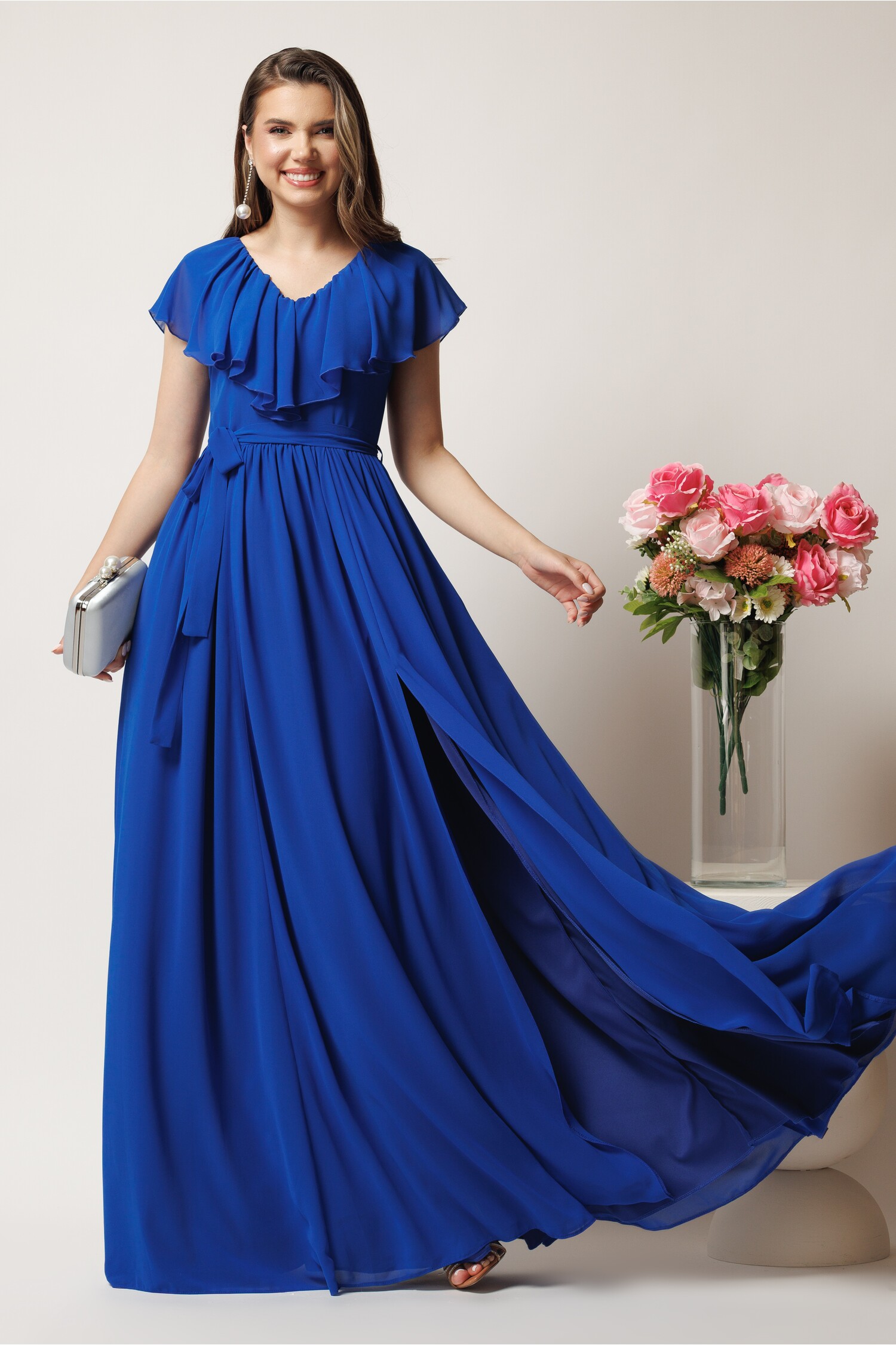 Rochie lungă albastră DY fashion din voal cu volănaș la bust și crăpătură pe picior Rochie lungă albastră DY fashion din voal cu volănaș la bust și crăpătură pe picior
