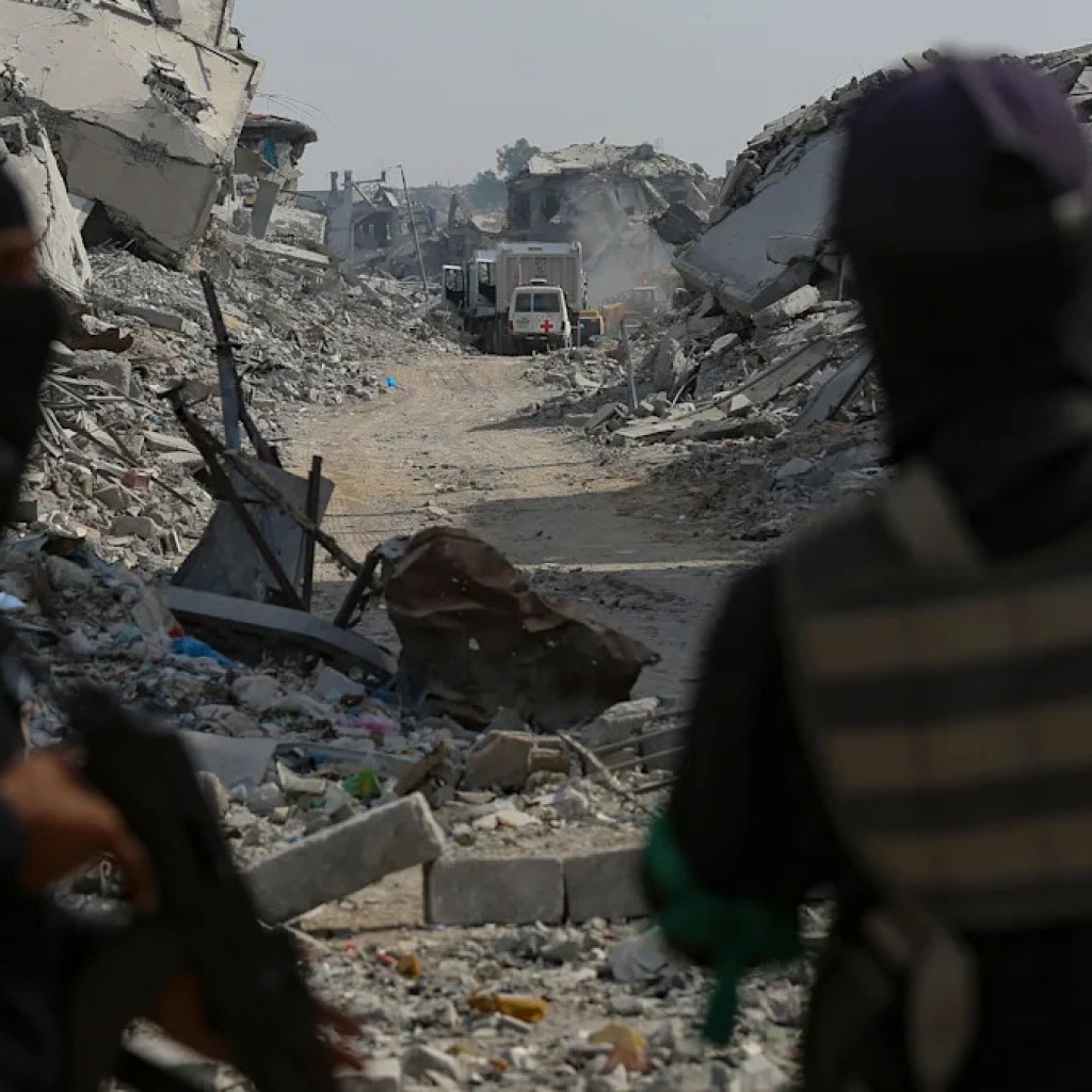 Hamas arms over three coffins it says comprise our bodies of Gaza hostages Hamas arms over three coffins it says comprise our bodies of Gaza hostages