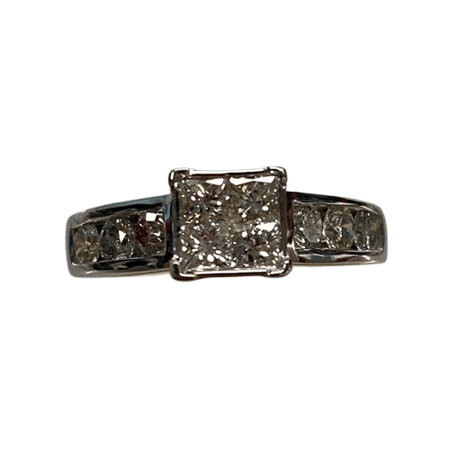 Ladies 14ct White Gold 10 Stone Diamond Ring. 4 Princess Cut Square Invisible Diamonds. With 6 Round Brilliant Cut Diamonds Channel Set Stones Set in Swept Up Shoulders. TDW 1.30ct. Size N/7 . With Valuation Certificate – (NG 143712)