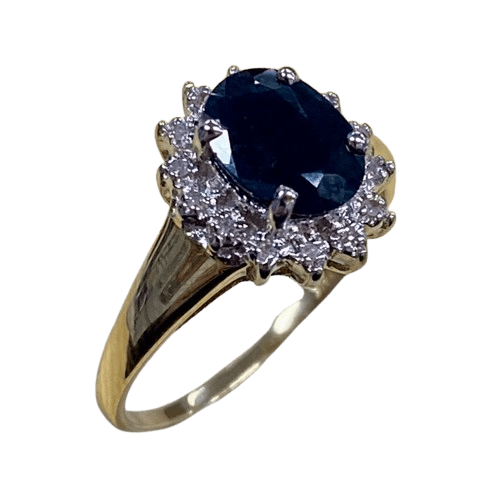 Ladies 9ct Yellow Gold 15 Stone Diamond & Sapphire Ring. Oval Sapphire In Rhodium 4 Claw Setting, Surrounded by 14 Single Cut Diamonds Illusion Bead Set in Rhodium Plated Basket, In Swept Up Shoulders. TDW 0.07ct. Size M/6.5, With Valuation Certificate – (NG 1307520)