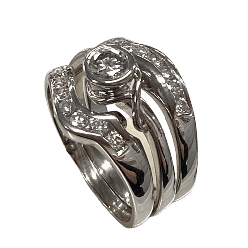 Ladies 18ct White Gold 3 Ring Set. Rub Over Set 0.30ct Round Brilliant Cut Diamond, With 7 Round Brilliant Cut Channel Set In Fitted Bands Each Side. TDW 0.72ct. Size O  With Valuation Certificate.